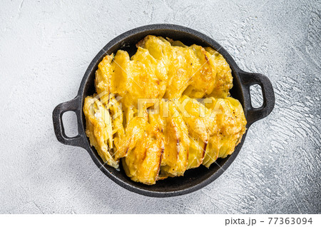 Baked Potato Gratin Dauphinois in a pan. White background. Top View 77363094