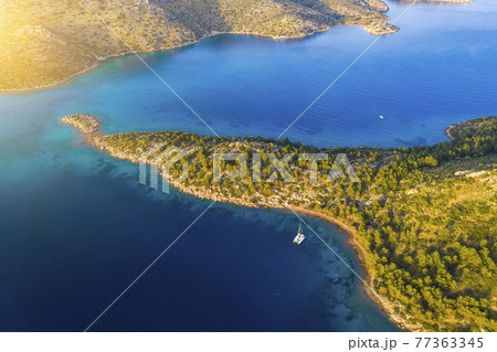 Aerial view of a catamaran yacht in the blue sea. Yachting, luxury vacation at sea. 77363345