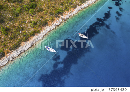 Yacht sailing near the rocky coast in Turkey. Luxury vacation at sea Yacht sailing near the rocky coast in Turkey. Luxury vacation at sea 77363420