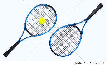 Tennis rackets with ball on white 77363834