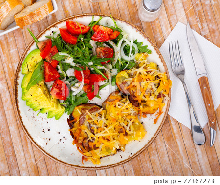 Pork with baked potatoes and vegetable salad 77367273