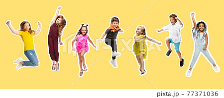 Group of elementary school kids or pupils jumping in colorful casual clothes on yellow background. Collage. 77371036