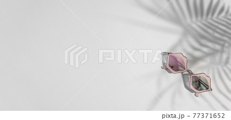 Funky sunglasses in pink lips shape on gray background with tropical shades, copy space,banner Funky sunglasses in pink lips shape on gray background with tropical shades, copy space,banner 77371652