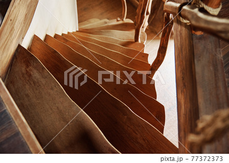 Old wooden staircase with railings 77372373