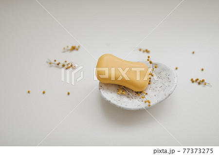 Handmade natural soap on white floral background. Soap making. Soap bars. Spa, skin care. Natural Organic spa cosmetic products on white table from above 77373275