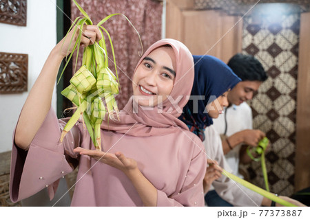 group of friend and family making ketupat together for eid fitr 77373887