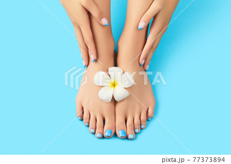 Manicure, pedicure beauty salon concept. Womans feet on blue background 77373894