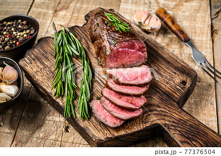 Barbecue Sliced veal tenderloin meat steak. wooden background. Top view Barbecue Sliced veal tenderloin meat steak. wooden background. Top view 77376504