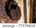 Rusty old padlock on an old metal door 77378810