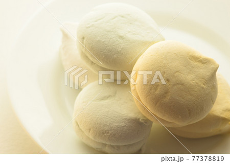 Delicious colored marshmallows with different flavors on a round plate 77378819