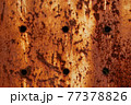 Texture of a rusty metal surface with holes, closeup 77378826