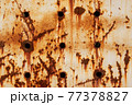 Texture of a rusty metal surface with holes, closeup 77378827