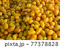 Yellow tomatoes selling fresh vegetables 77378828