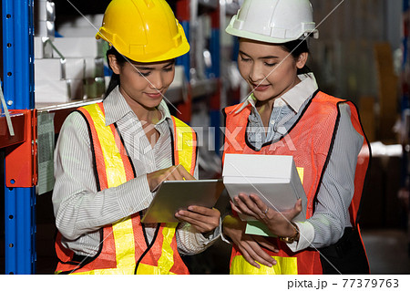 Female warehouse worker working at the storehouse Female warehouse worker working at the storehouse 77379763