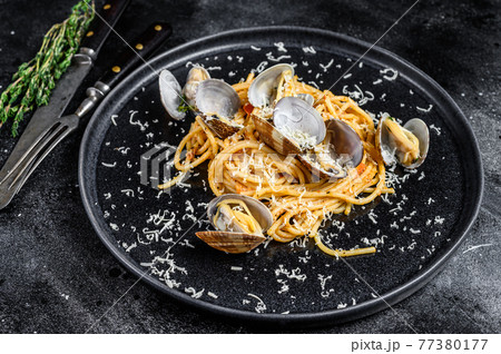 Seafood Spaghetti pasta with Clams vongole in a plate. Black background. Top view 77380177