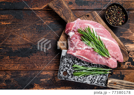 Fresh Raw pork shoulder meat cut with ingredients and spices on kitchen background. Dark wooden background. Top view. Copy space Fresh Raw pork shoulder meat cut with ingredients and spices on kitchen background. Dark wooden background. Top view. Copy space 77380178