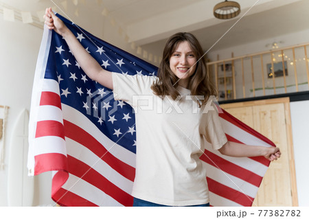 A resident of America celebrates a national holiday. The American flag. Democracy, freedom, independence A resident of America celebrates a national holiday. The American flag. Democracy, freedom, independence 77382782