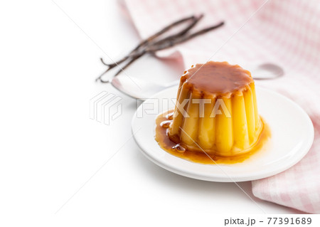 Sweet vanilla pudding. Sweet dessert with caramel topping. 77391689