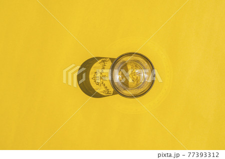glass with a hard shadow on a colored background glass with a hard shadow on a colored background 77393312