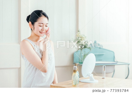 ファンデーション・パウダー・メイクする女性 77393784