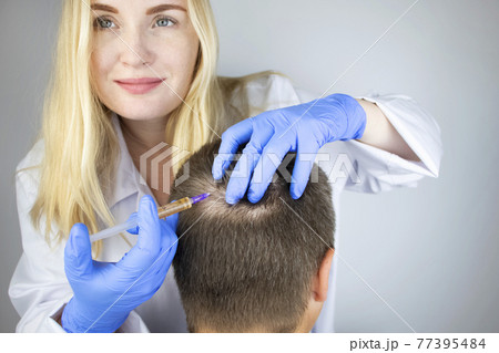 The doctor trichologist conducts mesotherapy or plasma therapy. Treatment of alopecia. Hair loss, alopecia, pruritus, burning head or seborrhea 77395484