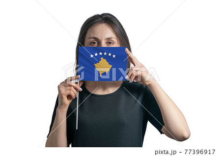 Happy young white woman holding flag Kosovo flag and covers her face with it isolated on a white background 77396917