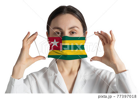 Respirator with flag of Togo Doctor puts on medical face mask isolated on white background Respirator with flag of Togo Doctor puts on medical face mask isolated on white background 77397018