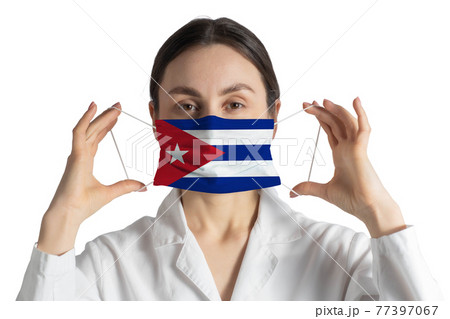 Respirator with flag of Cuba Doctor puts on medical face mask isolated on white background 77397067