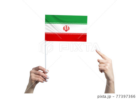 A beautiful female hand holds a Iran flag to which she shows the finger of her other hand, isolated on white background A beautiful female hand holds a Iran flag to which she shows the finger of her other hand, isolated on white background 77397366