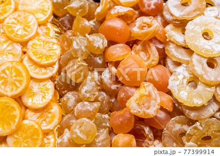 Candied lemons, peaches, plums and pineapple. Fruit background (Selective focus) 77399914