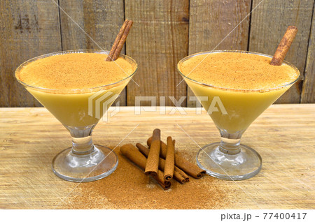Boza and cinnamon sticks, traditional Turkish cuisine drinks, on wooden background 77400417