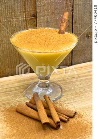 Boza and cinnamon sticks, traditional Turkish cuisine drinks, on wooden background 77400419
