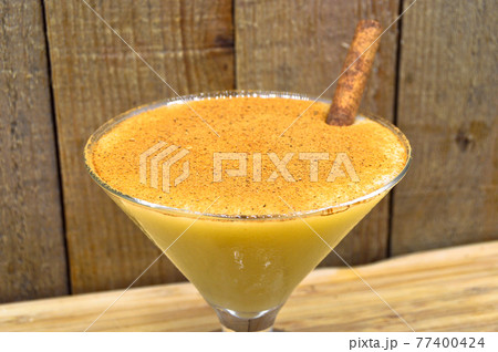 Boza and cinnamon sticks, traditional Turkish cuisine drinks, on wooden background 77400424