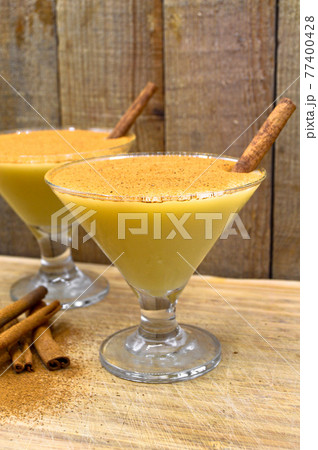 Boza and cinnamon sticks, traditional Turkish cuisine drinks, on wooden background 77400428