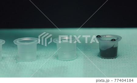 Photo of black ink for tattoo in studio Photo of black ink for tattoo in studio 77404184