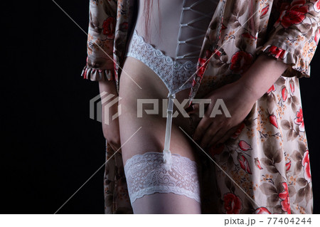 Photo of the woman in silk negligee and stockings 77404244