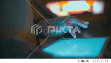Woman typing on tablet PC outdoor near subway entry 77405271