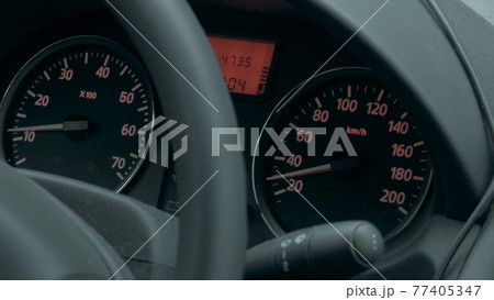 Car dashboard with low speed shown 77405347