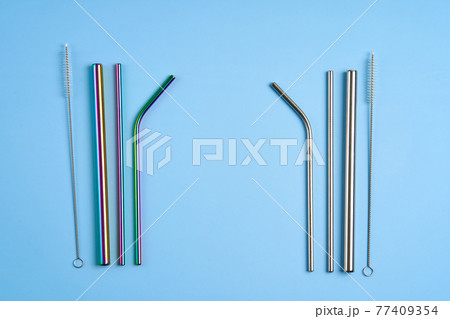 The modern trend towards caring for the environment. Kit of reusable metal beverage straws of various shape and diameters with cleaning tool The modern trend towards caring for the environment. Kit of reusable metal beverage straws of various shape and diameters with cleaning tool 77409354