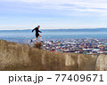 Man running in mountains and houses background 77409671