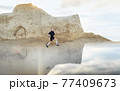 Man running in mountains on the sunrise 77409673