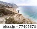 Runner standing on mountains and open arms 77409678