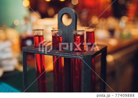 Laboratory glassware with alcohol cocktail's on chemical party. 77409888