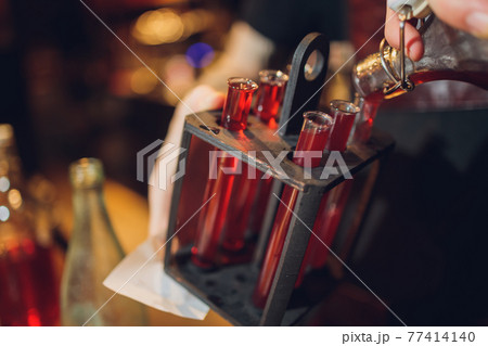 Laboratory glassware with alcohol cocktail's on chemical party. 77414140