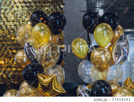 black and gold helium air balloons on white background, celebrate, party. 77414141