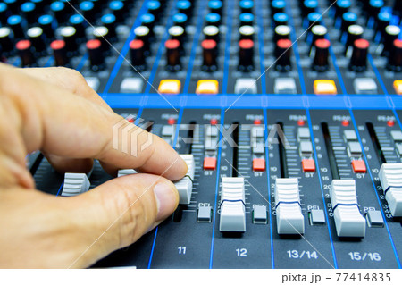 hands of Men are controlling the console of a large hi-fi system. Sound equipment. Control panel of a digital studio hands of Men are controlling the console of a large hi-fi system. Sound equipment. Control panel of a digital studio 77414835