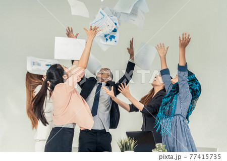 Business people throwing papers in the office. 77415735