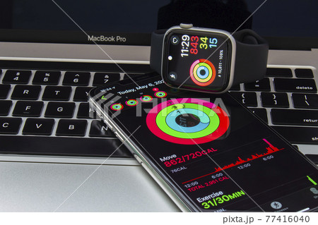 Calgary, Alberta Canada. May 7, 2021. An iPhone and an Apple Watch with the Fitness app. 77416040