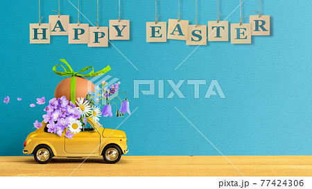 Retro car carrying an easter egg and bunch of flowers on the roof. Copy space 77424306