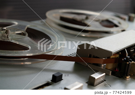 Old vintage reel-to-reel player. Tape recorder with spools. Bobbin tape recorder. 77424599